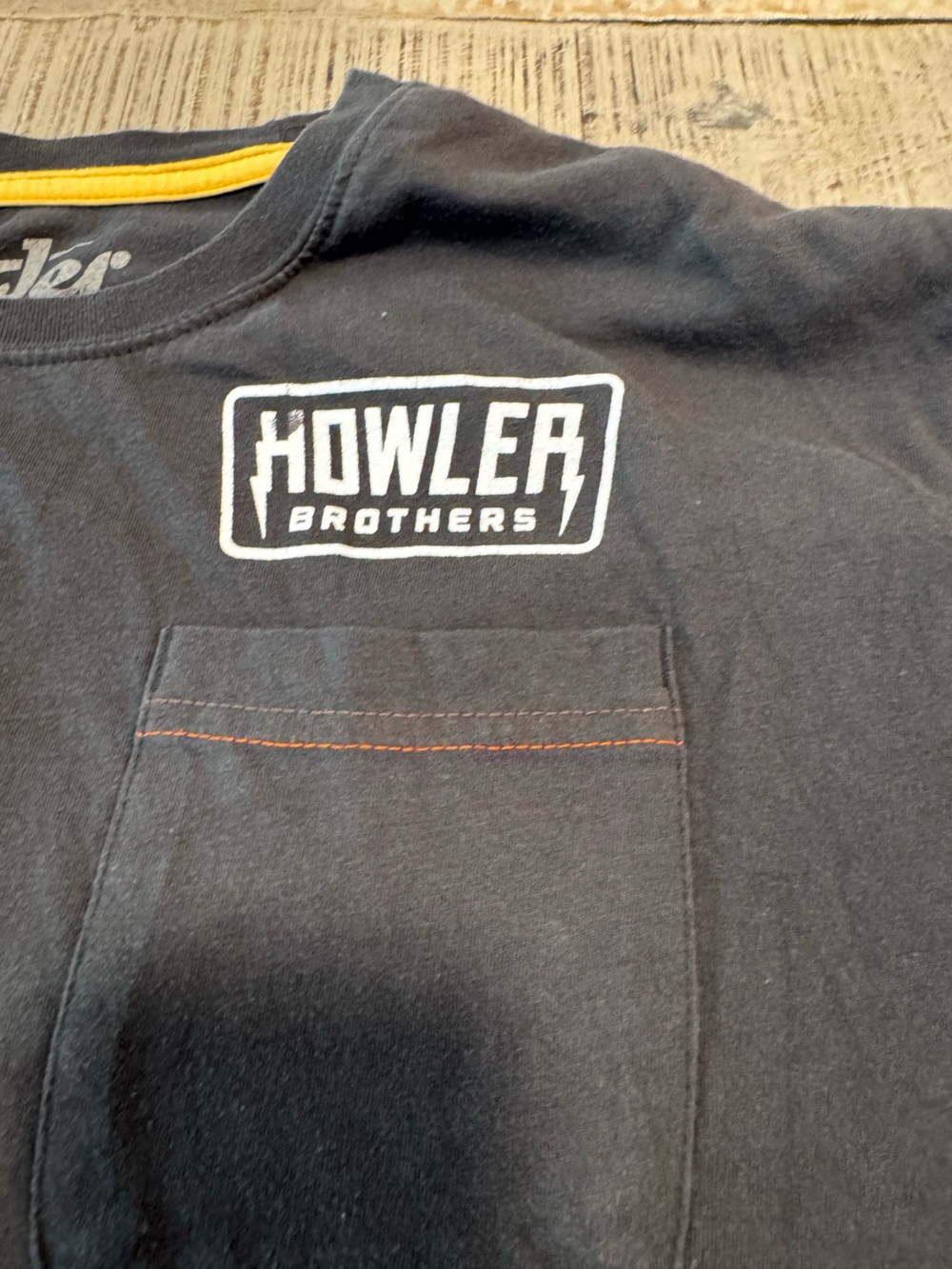 Howler Brothers charcoal tee with yellow neck trim